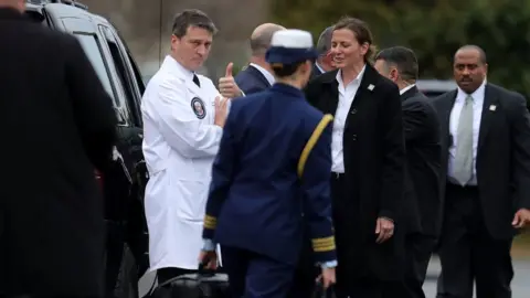 Getty Images Dr Jackson gives a thumbs-up after Mr Trump's physical examination