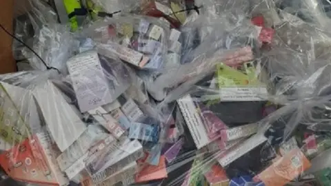 North Northamptonshire Council Pile of vapes, tobacco and cigarettes in labelled clear bags