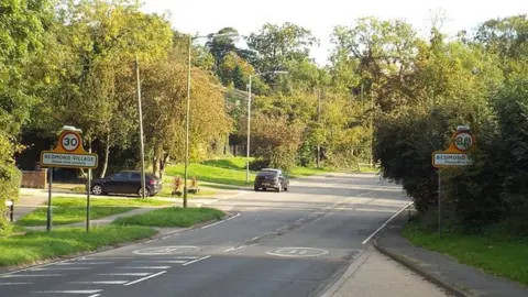 Malc McDonald/Geograph The Bedmond village signs either side of the street as the road enters Bedmond