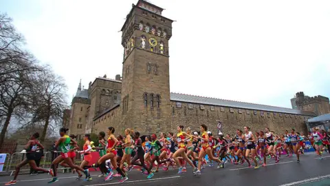 Getty Images Runners running past Cardiff Castle