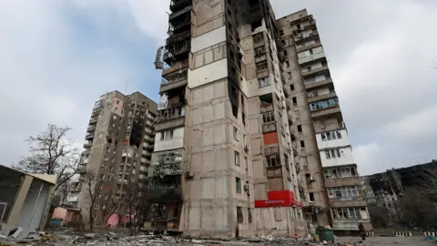 Reuters A residential building destroyed by fighting in Mariupol