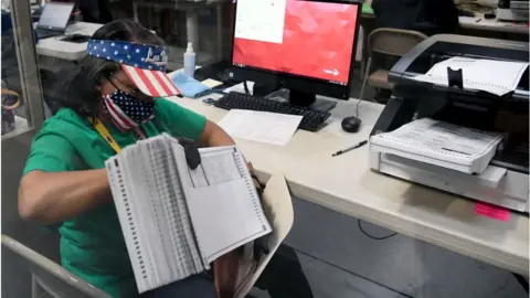 Getty Images An election worker in Nevada counts mail-in ballots