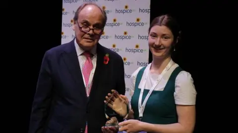 Dorothy House Hospice Care Jess Sheridan being handed an award