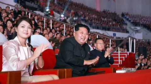 AFP/Getty Images This undated file picture released by North Korea's official Korean Central News Agency (KCNA) on October 19, 2015 shows North Korean leader Kim Jong-Un (C), accompanied by his wife Ri Sol-Ju (L).