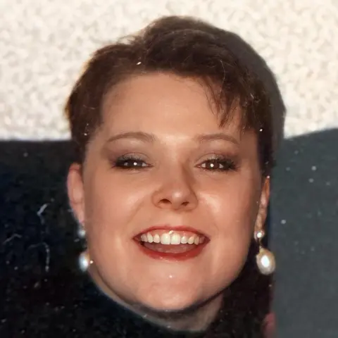 SBHA A girl with dark hair and wearing a dark top smiles at the camera