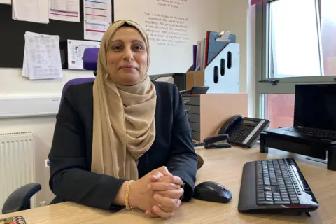 Feversham Girls' Secondary Academy's principal Sajida Muneer sitting at her desk