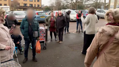 BBC Ben Moore People in a queue outside Sustain Foodbank in Tonbridge 