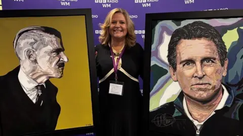 A woman with blonde wavy hair is wearing a black dress