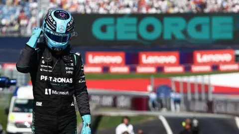 George Russell celebrates after claiming pole position in Austria 