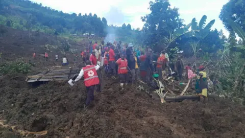 Rescue workers pull together to save survivors and recover bodies on a mountainside