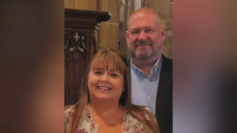 Supplied Image of Sonia and Mark inside a church. They are both smiling at the camera.