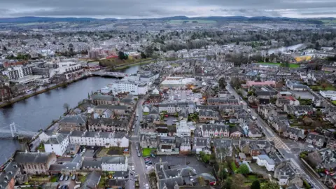 Getty Images A view across Inverness, the River Ness and rows of houses and other buildings either side of the river.
