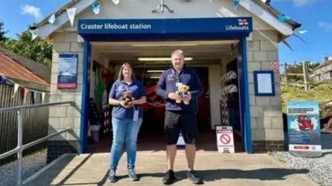 Allan Thornhill Allan and Helen Thornhill standing outside a lifeboat station