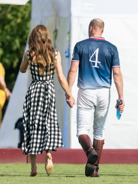 Getty Images A picture of the Princess of Wales on the left and the Prince of Wales walking away after the polo match.