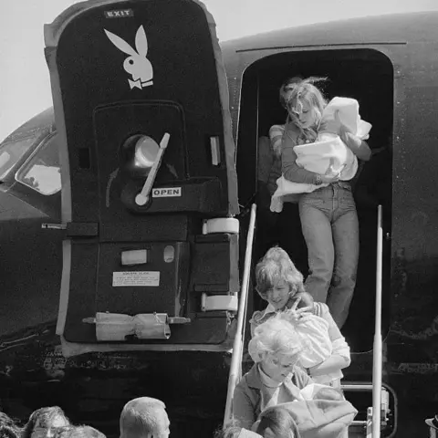 Getty Images: “Playboy Bunnies” carried Vietnam babies from Hugh Hefner’s private jet, which ordered him to Vietnam to support Operation Babylift 