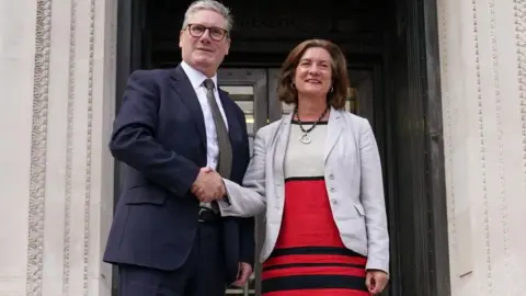 PA Media Sir Keir Starmer and First Minister Eluned Morgan shake hands