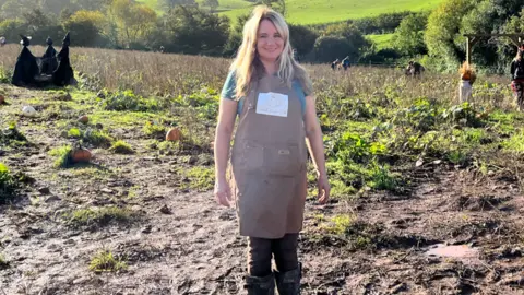 Claire Norris, who runs the Quantock Pumpkin Patch near Kilve, standing in a field of pumpkins.