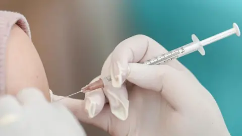 REUTERS/Athit Perawongmetha/File Photo A vaccine being injected via syringe into a person's arm