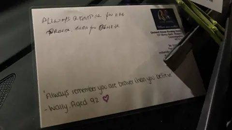 Cambridgeshire Police A note is written on a white piece of card which has been laminated. The note says "Always remember you are braver than you believe", and was written by Wally aged 92.