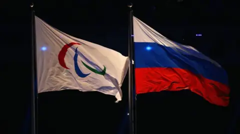 Paralympic flag and Russia flag flying side-by-side