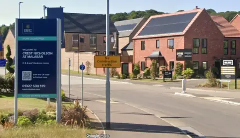 A new build housing estate with a navy blue sign that has "Crest Nicholson at Malabar" written on it.