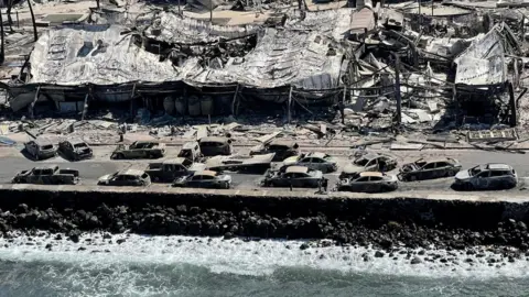 Reuters Burnt-out buildings and cars on Front Street after a wildfire ripped through Lahaina