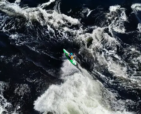 Lorne MacLeod A kayaker navigating powerful white-water rapids.