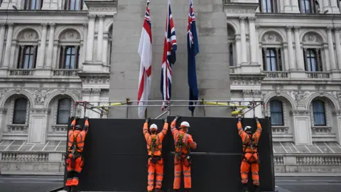 Getty Images Workers erect a protective barrier around the Cenotaph in anticipation of protests tomorrow