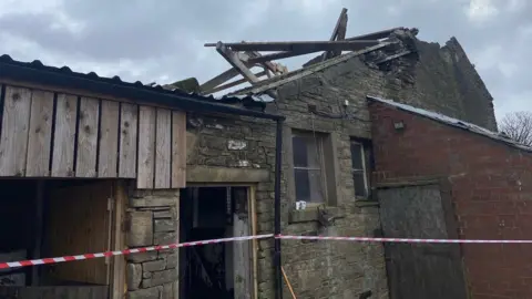 Damage caused to a farm building by a tornado in Tameside