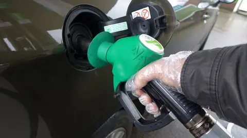 Getty Images Hand filling a car with petrol