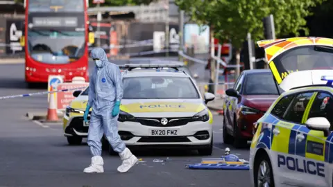 EPA Forensic police officers inspect the scene where two Jewish men are seriously injured after being stabbed in Golders Green.
