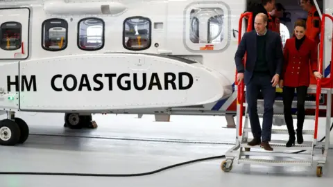 Getty Images Duke and Duchess of Cambridge walk off a Coastguard helicopter