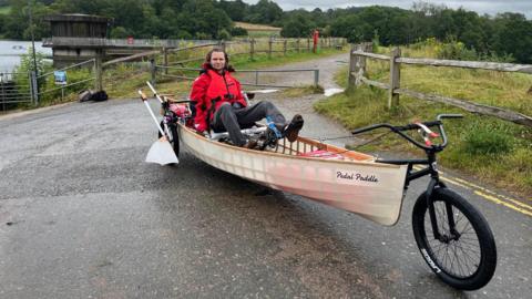 Ben Kilner in self-built amphibious bicycle canoe