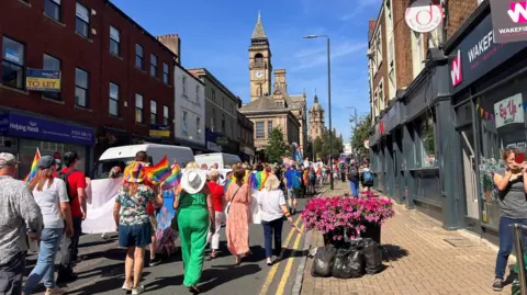 People march through the streets of Wakefield.