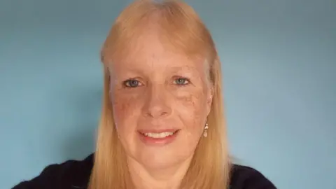 BBC Sarah against a plain blue background