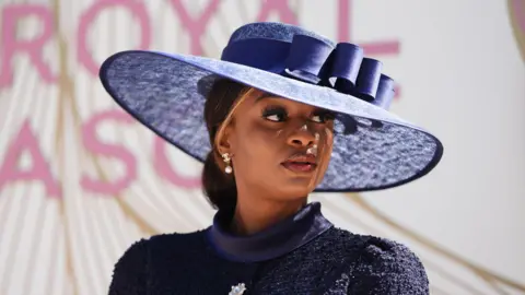 PA Media A picture of a woman with a dark blue hat, wearing a dark blue outfit, looking away from the picture.