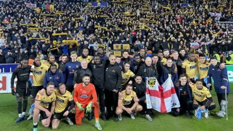 BBC/JAMES DUNN A picture of the Maidstone squad in front of the away end