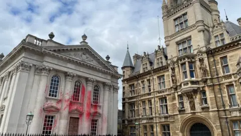 PA Media Red paint on Senate House in Cambridge