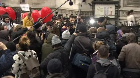 Supporters greet Mr Love at the Royal Courts of Justice