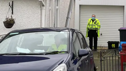 BBC A policeman outside a property in Lansdowne, Sebastopol