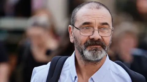 PA Media Andy Malkinson leaving court in London