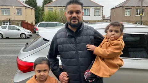 Steve Jones/BBC Sajid with two of his daughters