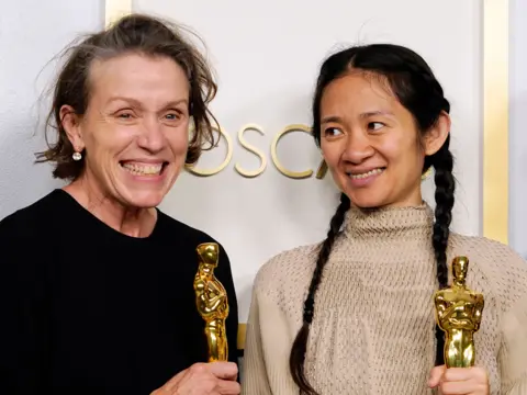Chris Pizzello / Pool via Getty Images Frances McDormand and Chloe Zhao pose in the press room at the Oscars on 25 April 2021, in Los Angeles