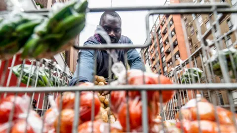 BBC/Shiraaz Mohamed Helder Massingue with his trolley of vegetables in Hillbrow, Johannesburg, South Africa