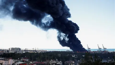 Reuters Smoke rises from a fire at the port of Iskenderun following an earthquake in Turkey