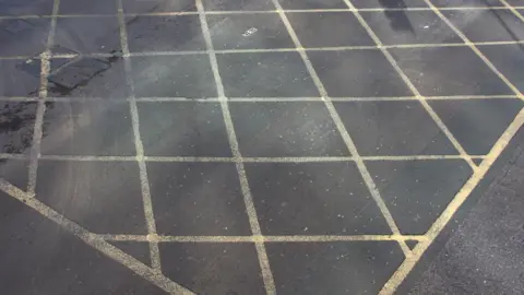 A general view of a yellow box junction painted onto a road.