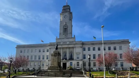 Barnsley town hall is a white stone building with a clock tower