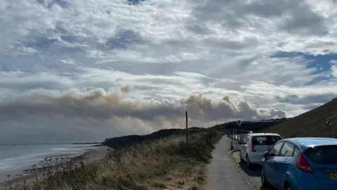 Image shows smoke from a moorland blaze in North Yorkshire drifting out to sea