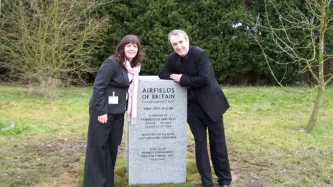 ABCT ABCT trustee Lynda Coxon with ABCT director-general Kenneth Bannerman standing at a memorial