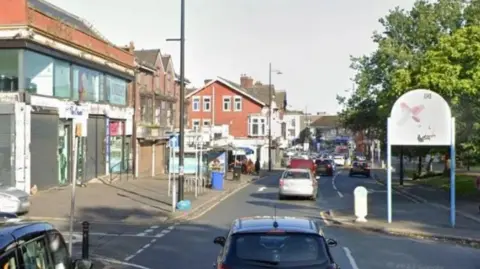 Cars on Slade Lane in Longsight